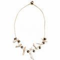 Pearl white coastal bohemian necklace with irregular shell-inspired pieces, bronze-tone bells, and cream braided cord by Browniecherry
