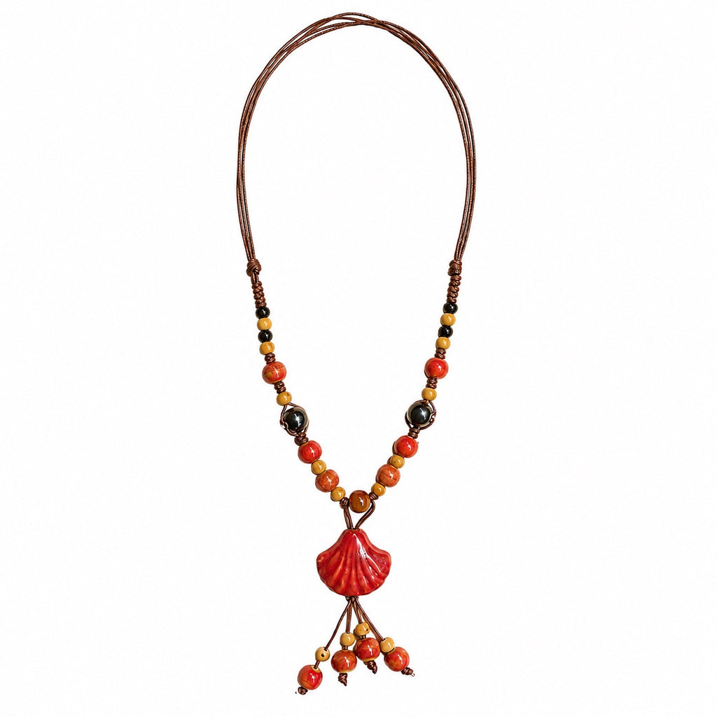 Sunset red seashell pendant bohemian rope necklace with hanging beads, warm colorful accents, and dark brown cord by Browniecherry

